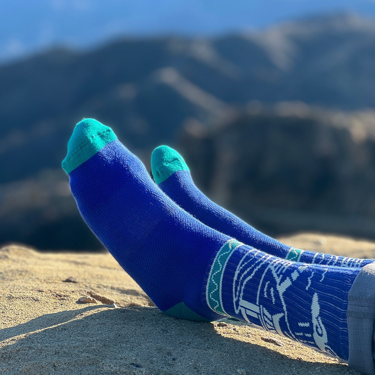 a man wearing blue color hiking sock with extended arch support band for improved stability