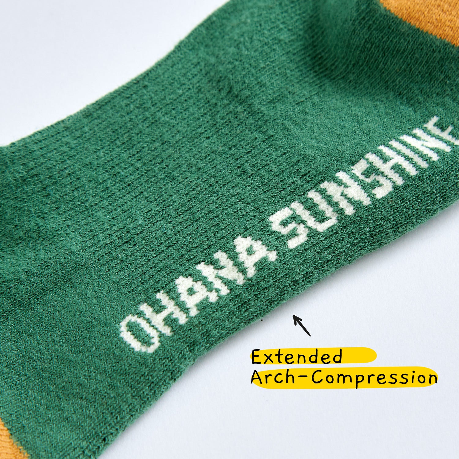 Close-up of Ohana Sunshine hiking socks in green color showing extended arch compression band for extra arch support
